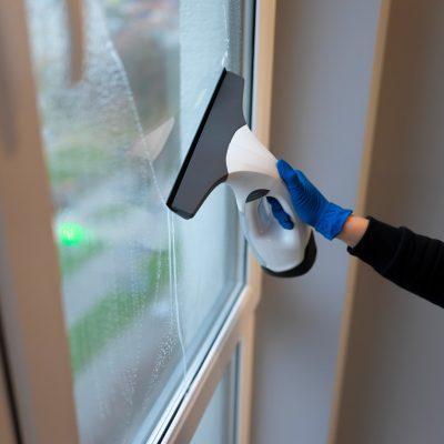 Window cleaning with electric vacuum cleaner. Clean windows concept